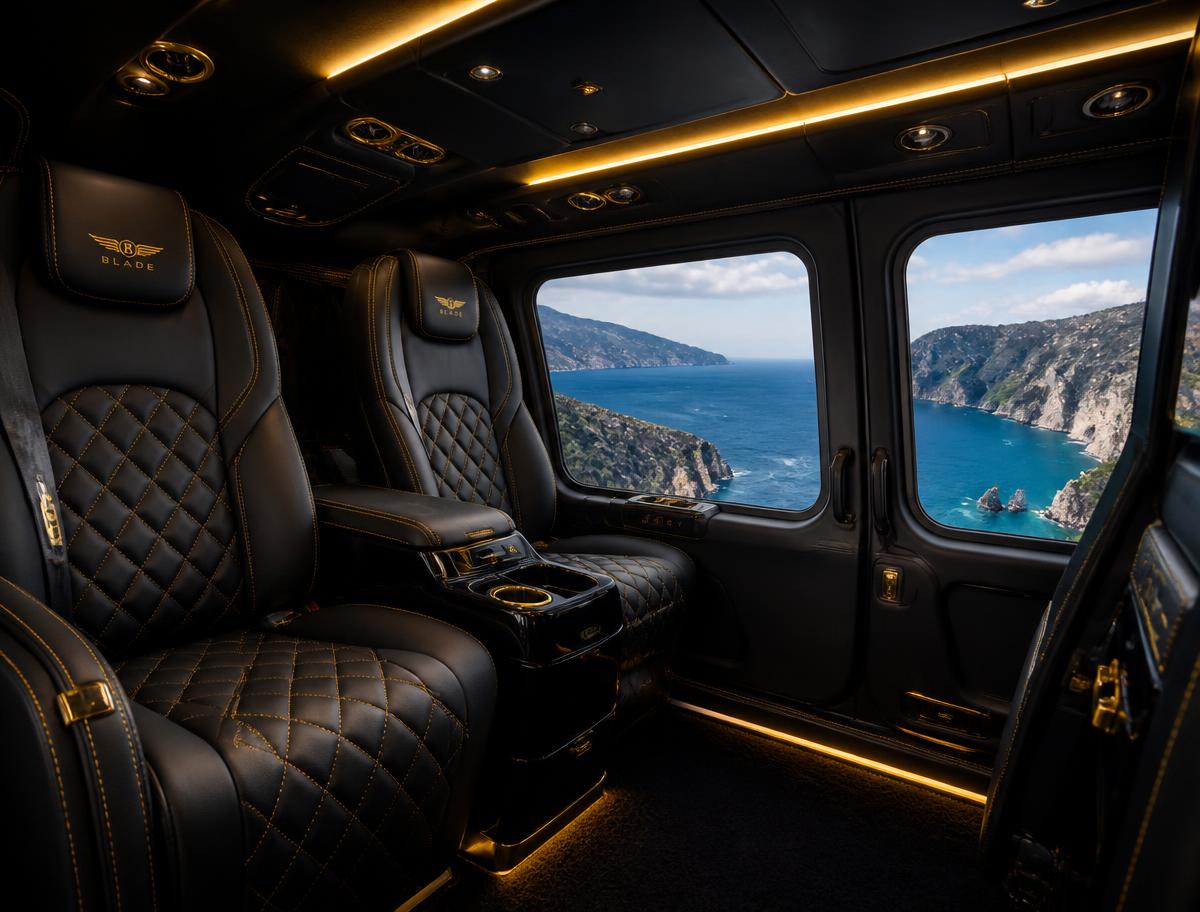 Quilted black leather seats inside a luxury helicopter cabin with a coastal view